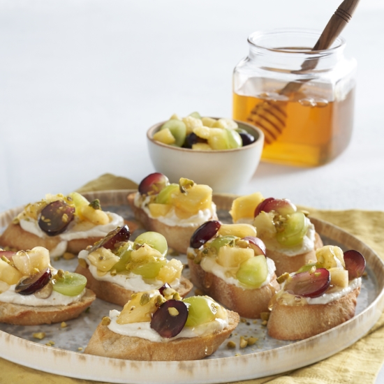 Pineapple Grape Bruschetta with Honey Orange Ricotta and Roasted Pistachios